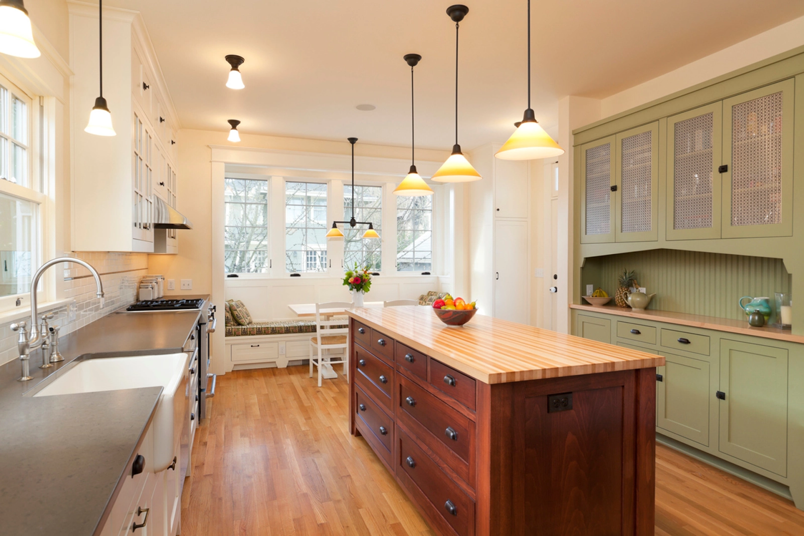 Warm farmhouse kitchen with wooden island, pendant lighting, and cabinetry. -kitchen remodel bellevue wa